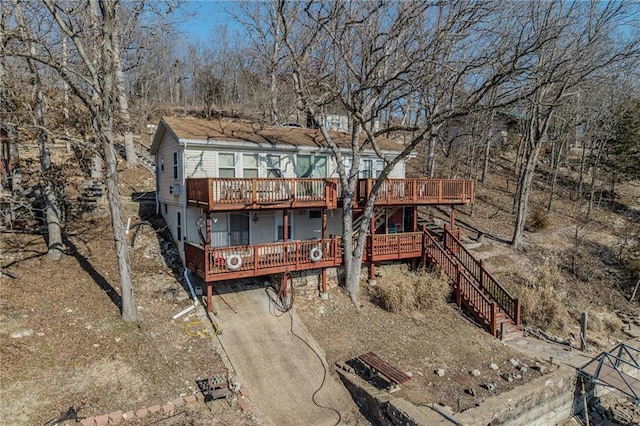 back of house with a wooden deck and stairs