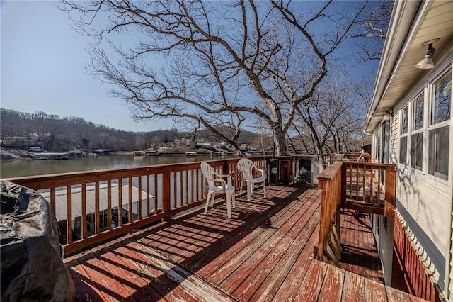 wooden terrace featuring a water view