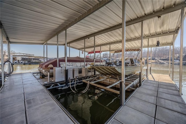 dock area with a water view and boat lift