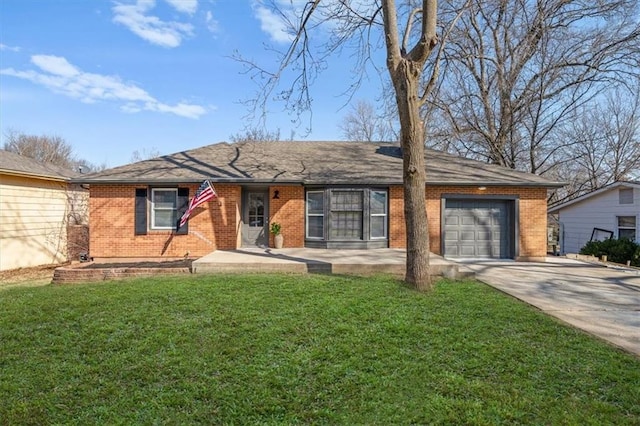 ranch-style home with a front yard, concrete driveway, brick siding, and an attached garage