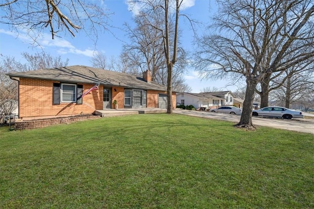 view of front of home featuring driveway, an attached garage, a chimney, a front lawn, and brick siding