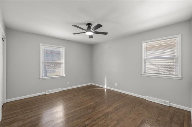 unfurnished room featuring a wealth of natural light, visible vents, and ceiling fan