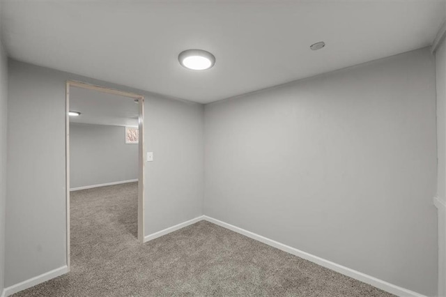 unfurnished room with carpet and baseboards