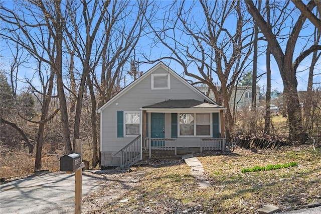 bungalow-style home with crawl space and roof with shingles