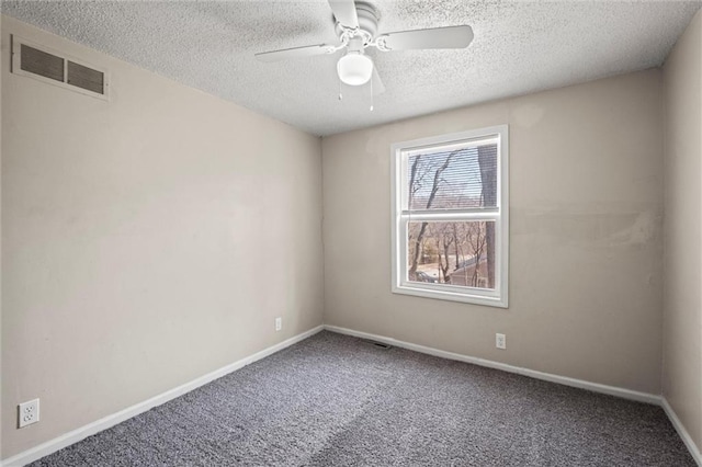 spare room featuring baseboards, visible vents, ceiling fan, a textured ceiling, and carpet flooring