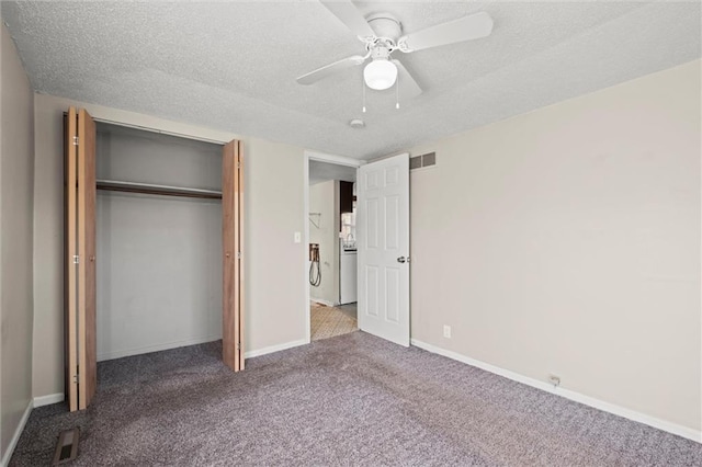 unfurnished bedroom with a textured ceiling, baseboards, and carpet floors