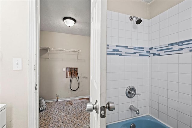 bathroom featuring a textured ceiling and shower / bathing tub combination