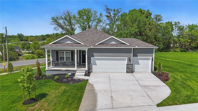 1605 Maci St, Belton, MO 64012 - view of front of property with covered porch, an attached garage, a front yard, and driveway
