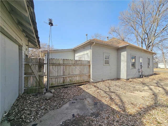 view of side of property featuring fence