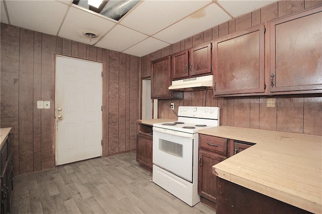 kitchen with under cabinet range hood, visible vents, light countertops, and white range with electric cooktop