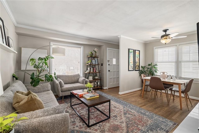 living room featuring wood finished floors, a wealth of natural light, and ornamental molding