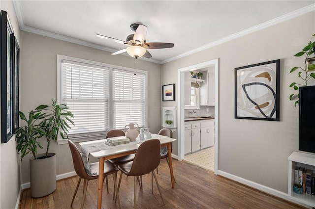 dining room featuring ornamental molding, ceiling fan, and wood finished floors