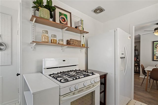 kitchen with visible vents, open shelves, white appliances, light wood finished floors, and ceiling fan