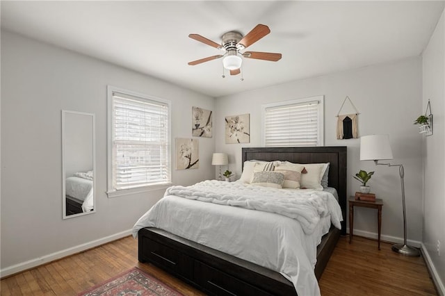 bedroom with ceiling fan, baseboards, and wood finished floors