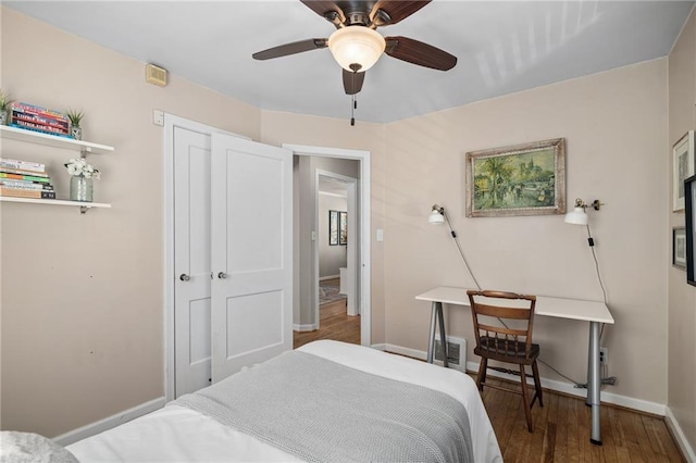 bedroom with ceiling fan, baseboards, and wood finished floors