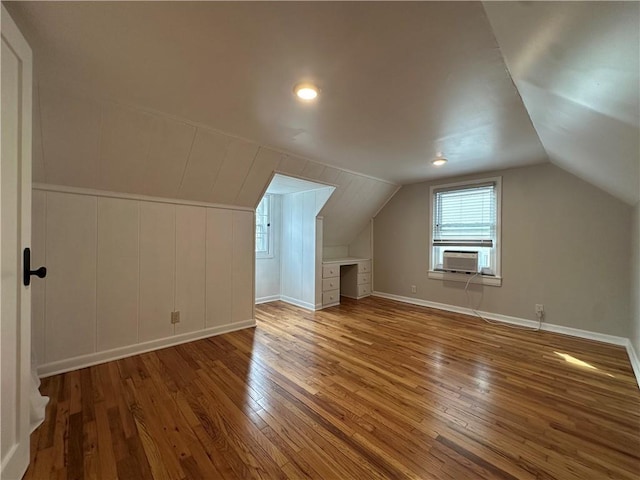 bonus room featuring baseboards, cooling unit, wood-type flooring, and lofted ceiling