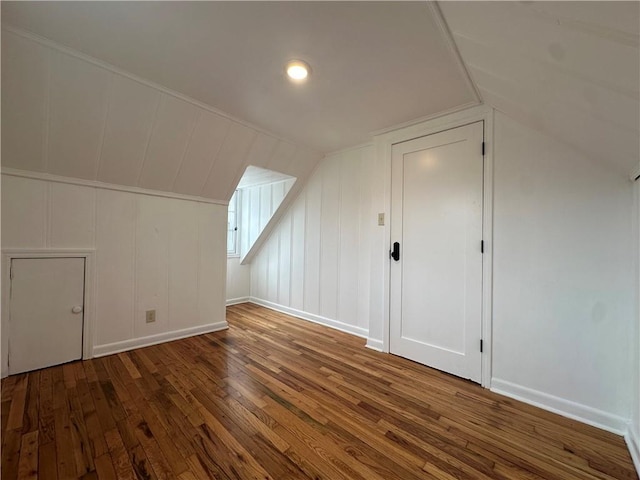 bonus room with vaulted ceiling, baseboards, and wood-type flooring