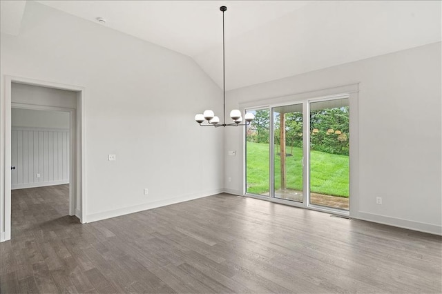 unfurnished room featuring a chandelier, wood finished floors, baseboards, and vaulted ceiling