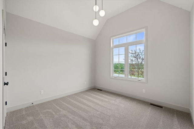 unfurnished room featuring vaulted ceiling, carpet, visible vents, and baseboards