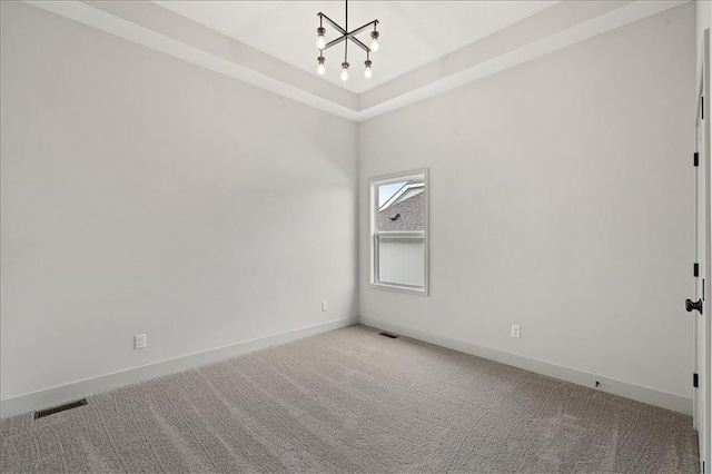 empty room featuring a notable chandelier, light colored carpet, visible vents, and baseboards