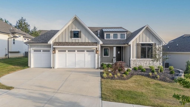 22109 W 80th Ter, Shawnee, KS 66220 - craftsman house with board and batten siding, concrete driveway, a front lawn, and roof with shingles