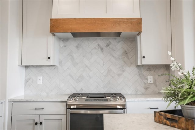 22109 W 80th Ter, Shawnee, KS 66220 - kitchen with gas range, decorative backsplash, wall chimney exhaust hood, light stone countertops, and white cabinetry