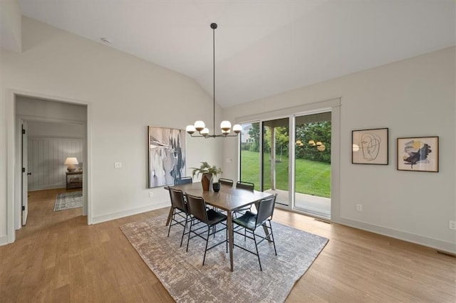 22109 W 80th Ter, Shawnee, KS 66220 - dining room with lofted ceiling, wood finished floors, and a chandelier