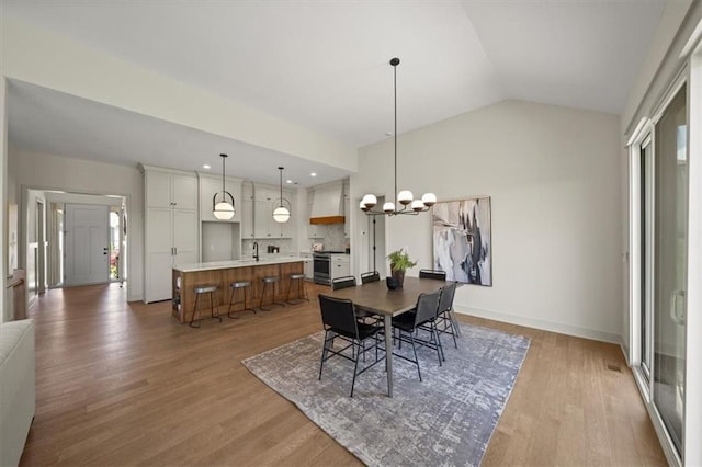 22109 W 80th Ter, Shawnee, KS 66220 - dining room with light wood-style floors, a chandelier, and lofted ceiling