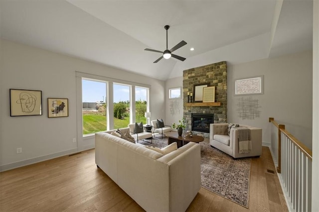 22109 W 80th Ter, Shawnee, KS 66220 - living area with a ceiling fan, a stone fireplace, wood finished floors, lofted ceiling, and recessed lighting
