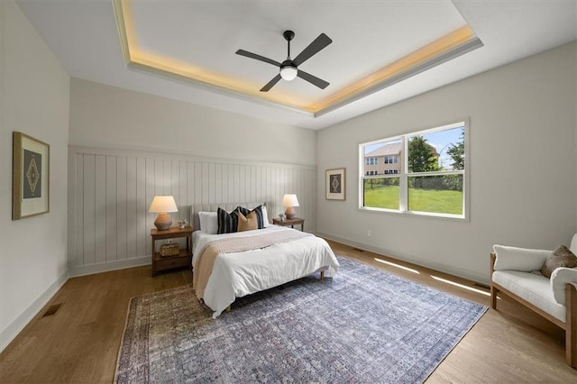 22109 W 80th Ter, Shawnee, KS 66220 - bedroom featuring a tray ceiling, wood finished floors, and ceiling fan