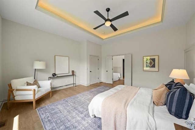 22109 W 80th Ter, Shawnee, KS 66220 - bedroom with a raised ceiling, wood finished floors, and ceiling fan