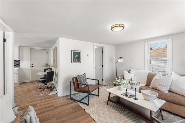 living room with baseboards and light wood finished floors