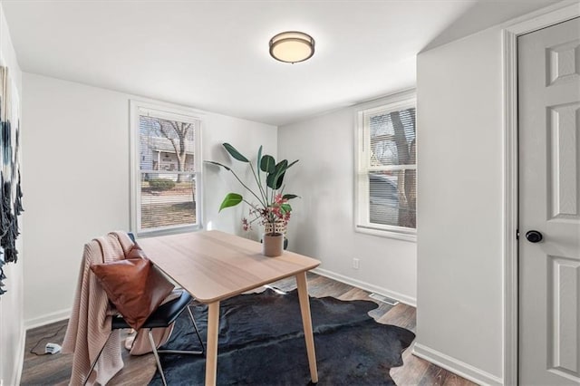 office area featuring plenty of natural light, wood finished floors, and baseboards