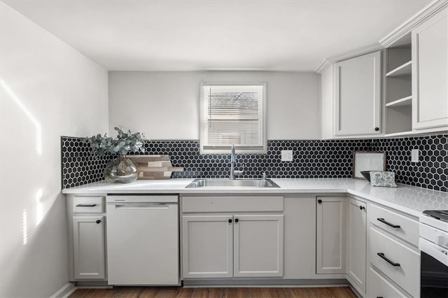 kitchen featuring white appliances, open shelves, a sink, decorative backsplash, and light countertops