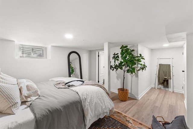 bedroom featuring recessed lighting, light wood-type flooring, and baseboards