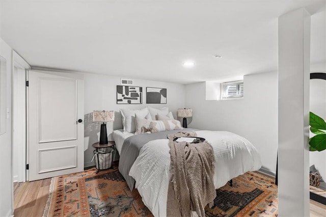 bedroom with visible vents and wood finished floors