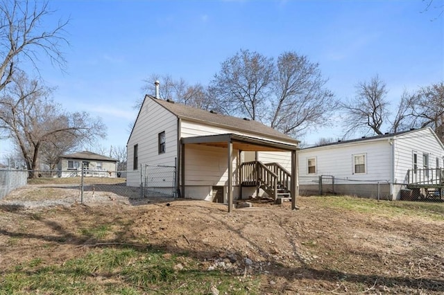 back of house featuring a fenced backyard