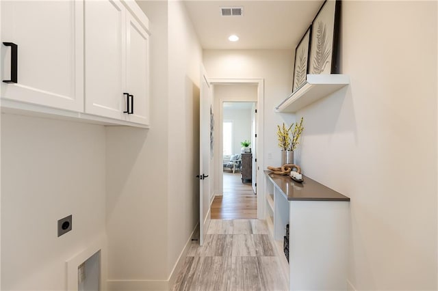 laundry area featuring electric dryer hookup, visible vents, recessed lighting, cabinet space, and baseboards