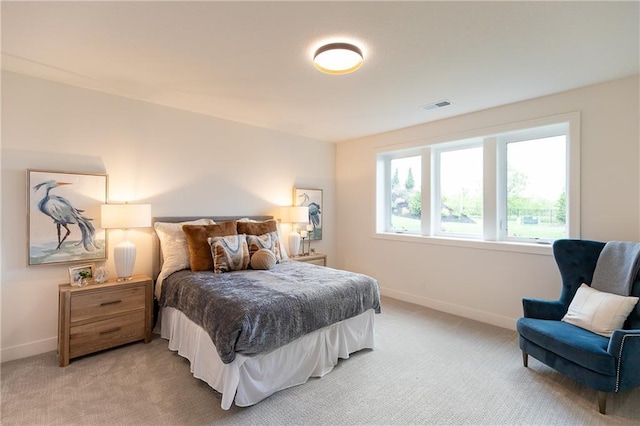 bedroom featuring light carpet, visible vents, and baseboards