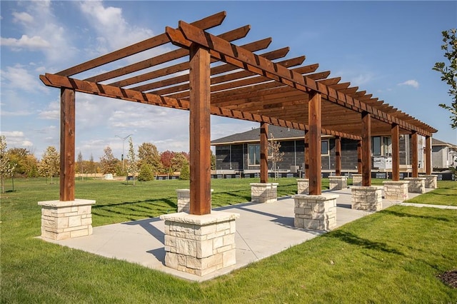 view of community featuring a pergola and a yard