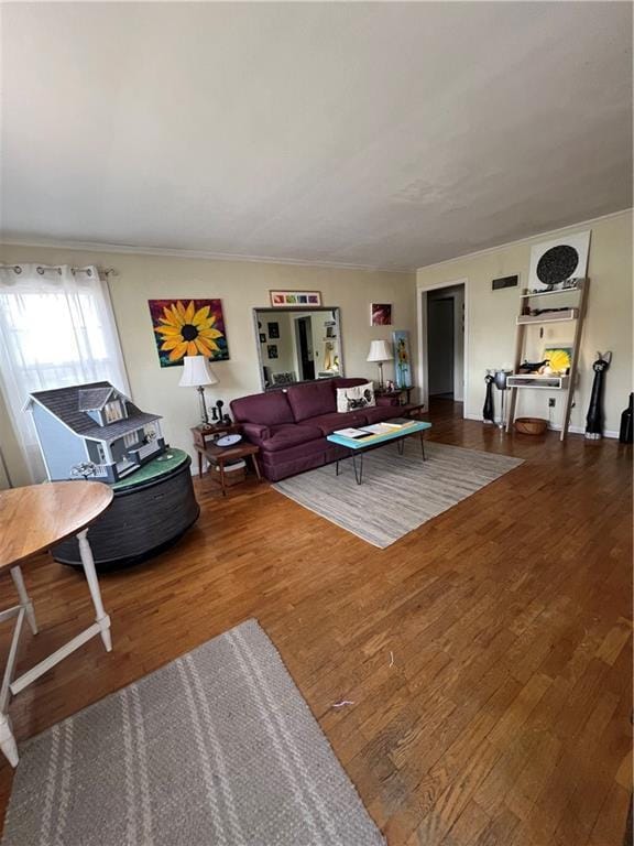 living area featuring crown molding and wood finished floors