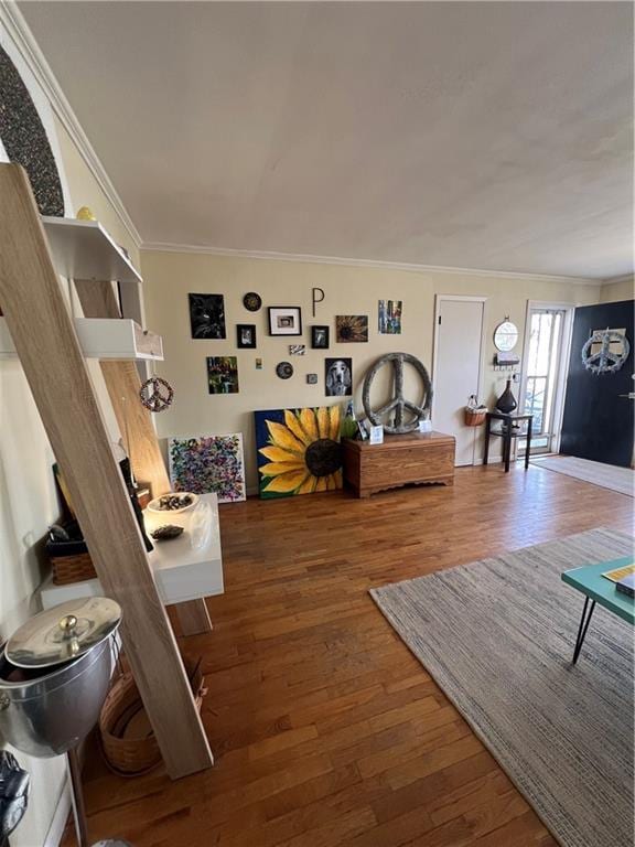 living room featuring wood finished floors and crown molding