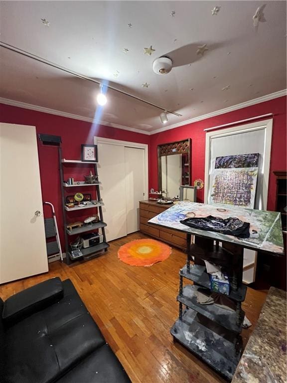 game room featuring wood finished floors and ornamental molding