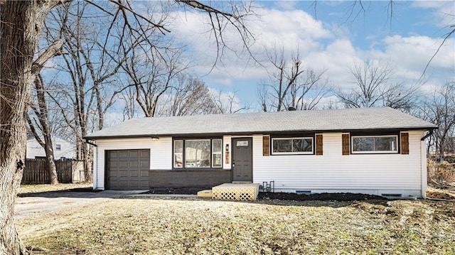 ranch-style home featuring an attached garage, driveway, and fence