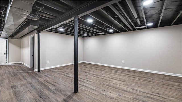 finished basement featuring wood finished floors and baseboards