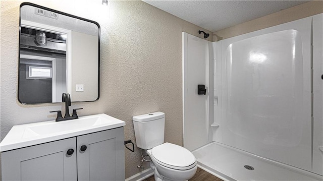 bathroom featuring walk in shower, a textured wall, and a textured ceiling