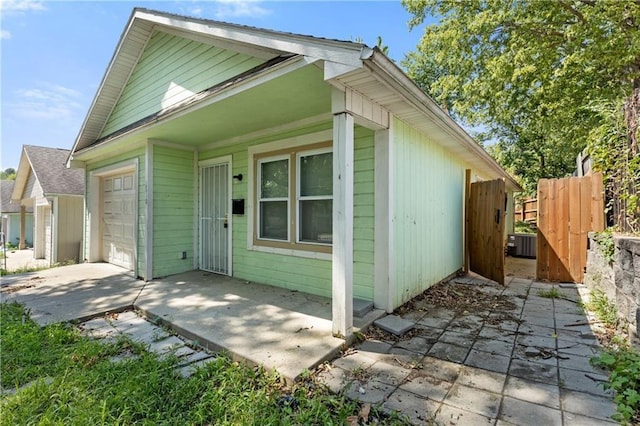 view of front of home featuring an attached garage and fence