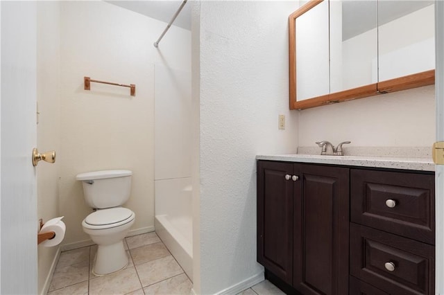 bathroom with tile patterned floors, toilet, a walk in shower, baseboards, and vanity