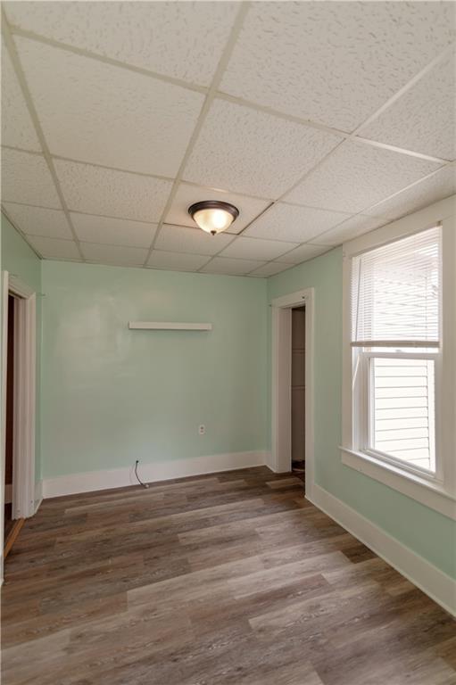 713 N 13th St, Atchison, KS 66002 - spare room featuring a drop ceiling and wood finished floors