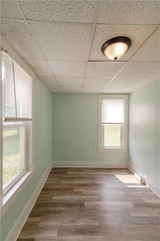 713 N 13th St, Atchison, KS 66002 - spare room with healthy amount of natural light, wood finished floors, and a paneled ceiling